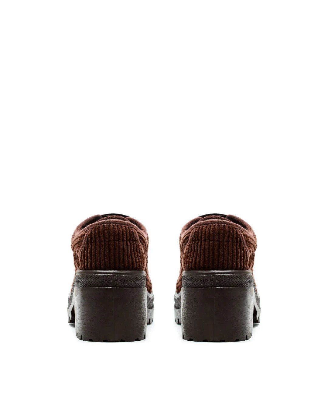 Pair of brown corduroy lug sole sneakers with chunky black heels on white background