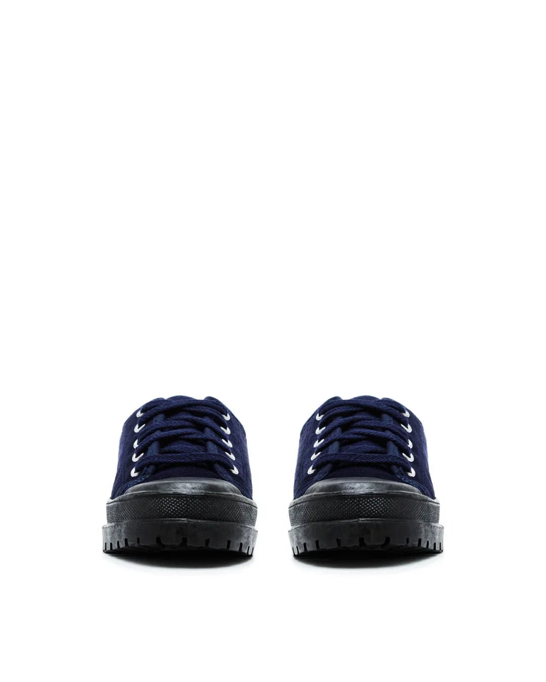 pair of navy blue canvas low top sneakers with black rubber soles on white background