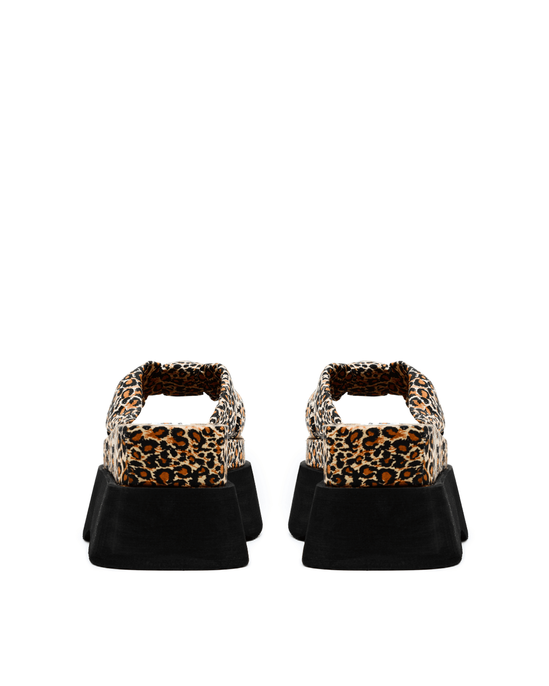 pair of leopard print platform slide sandals with black soles on white background