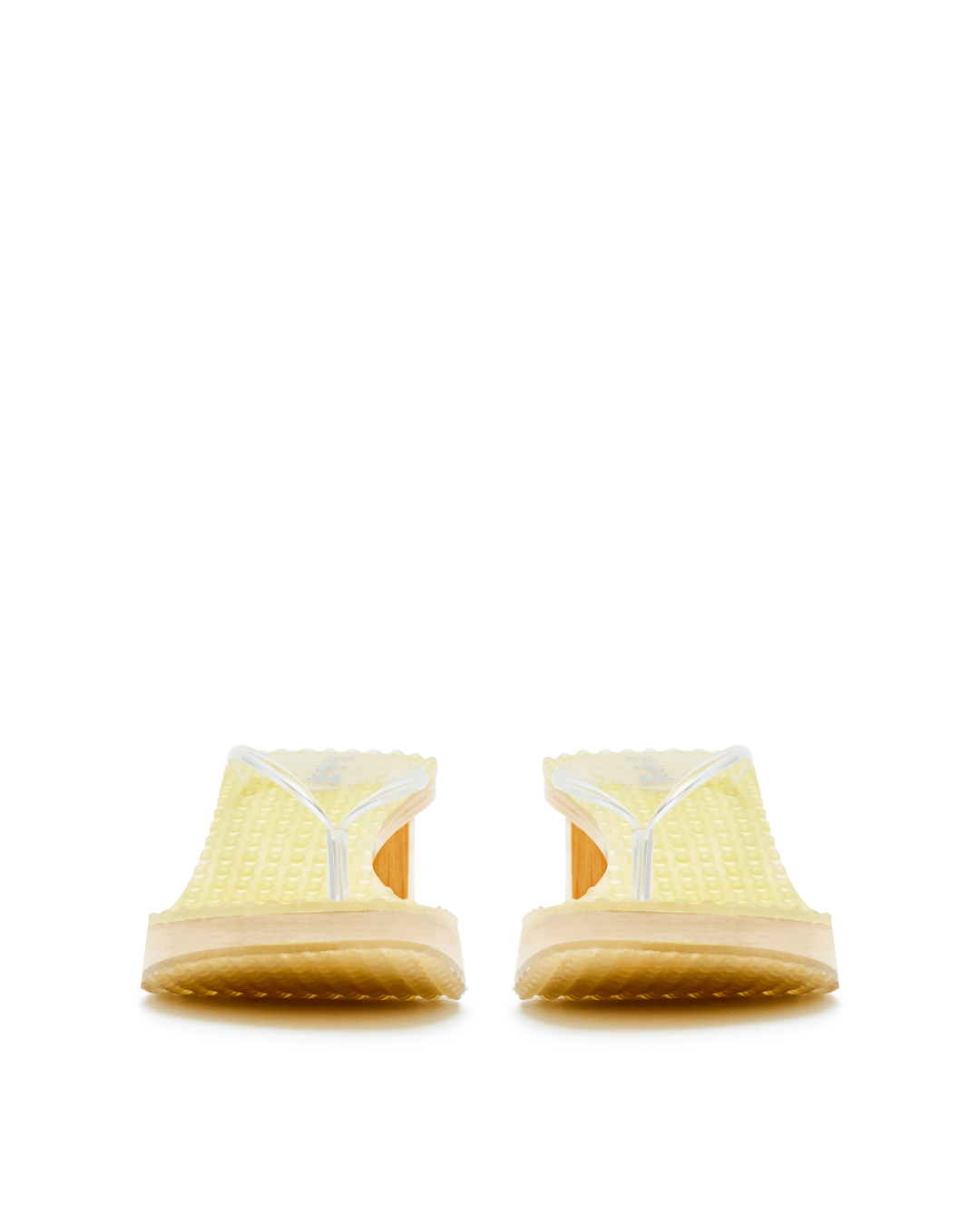 Pair of yellow platform sandals with clear straps and textured soles on a white background.