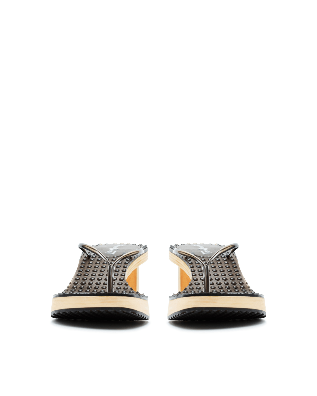 Pair of gray platform sandals with round studs and chunky beige soles on white background