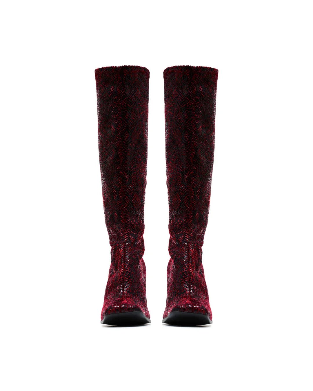 Pair of tall, red snakeskin-patterned boots with black soles on a white background
