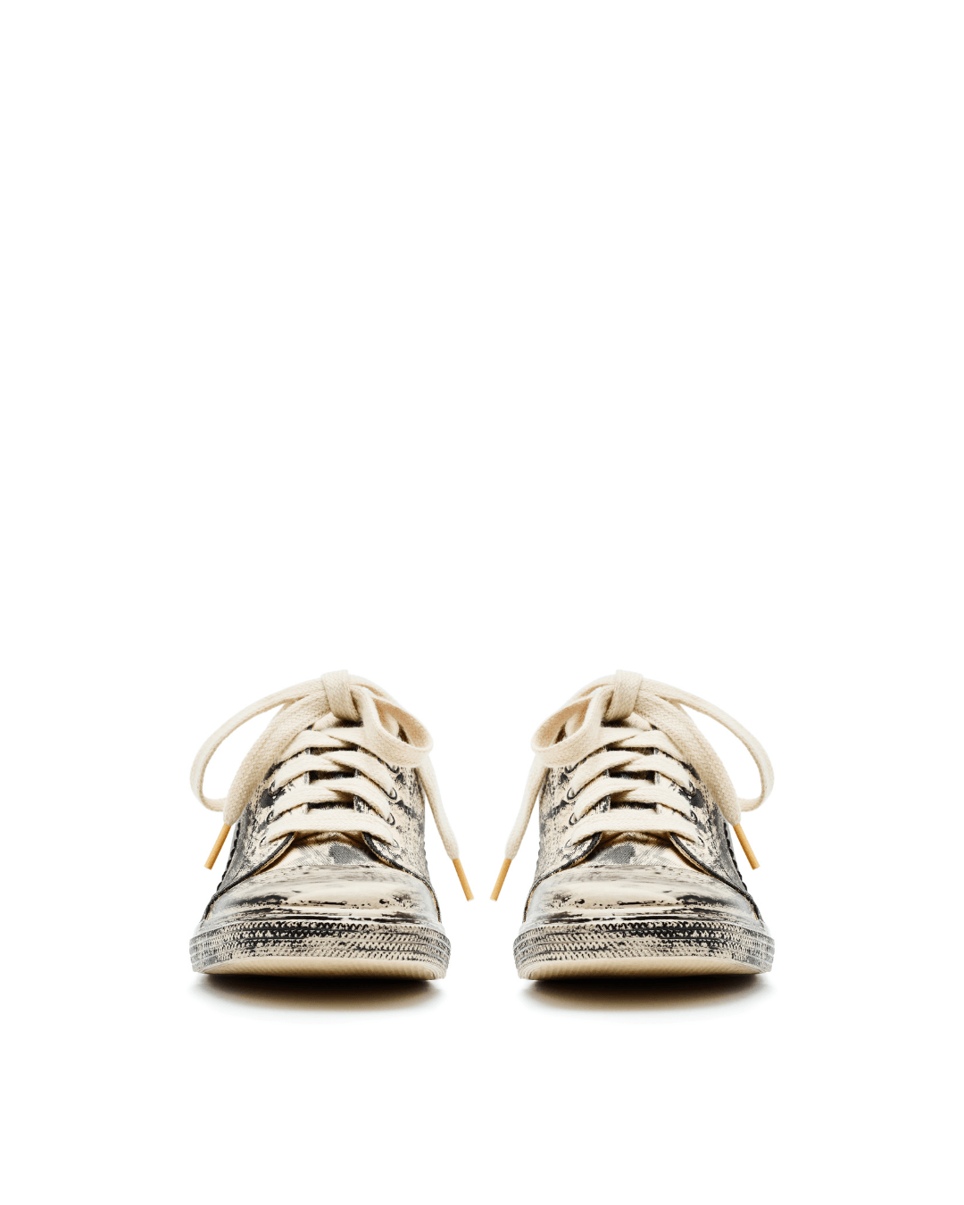 Pair of beige mule sneakers with snakeskin pattern and white laces on white background