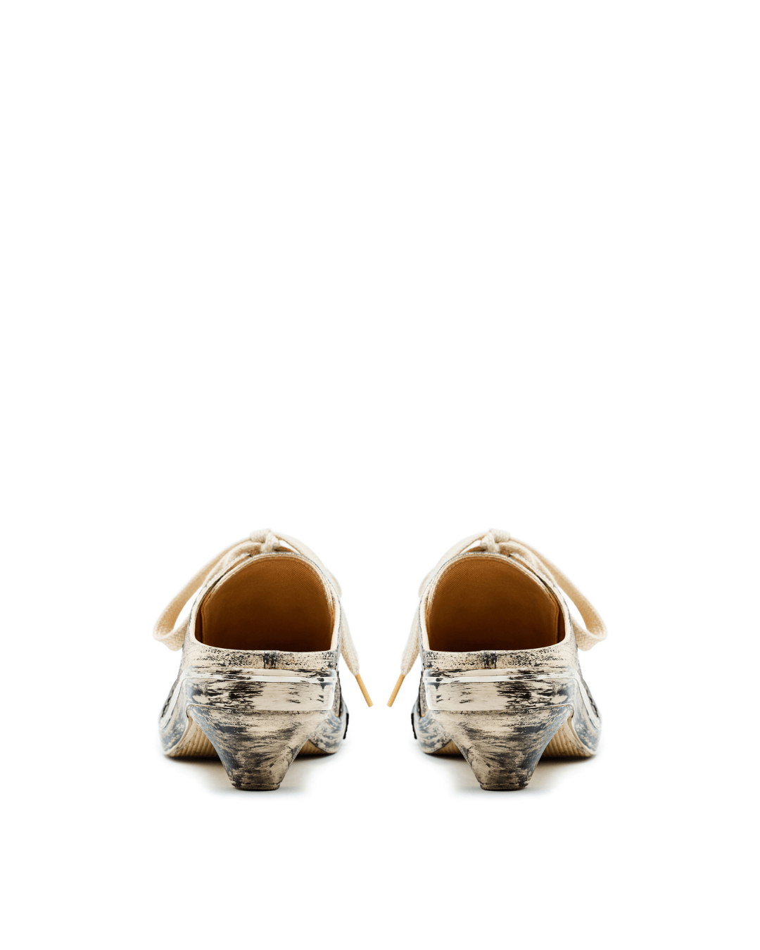 Pair of distressed white mule sneakers with laces, viewed from the back on white background.