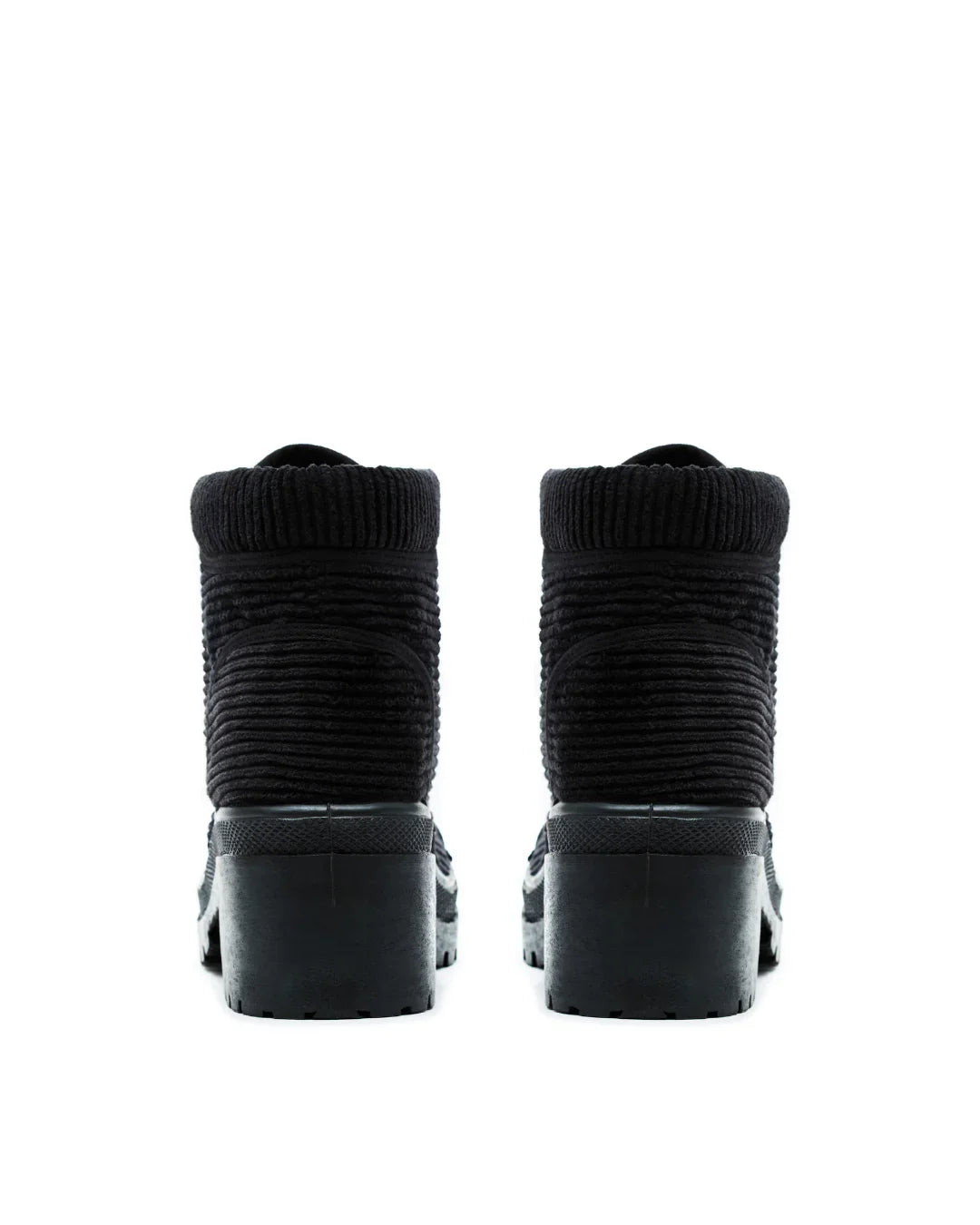 back view of black ribbed ankle boots with chunky heels on white background