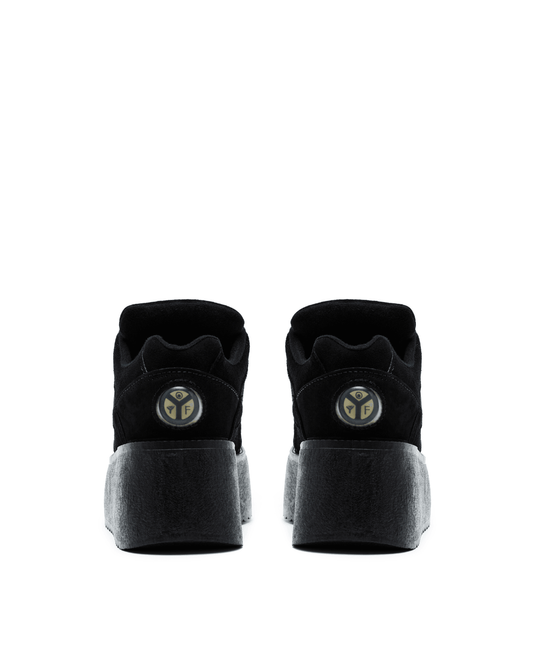 black platform sneakers with thick gray soles, viewed from the back on a white background