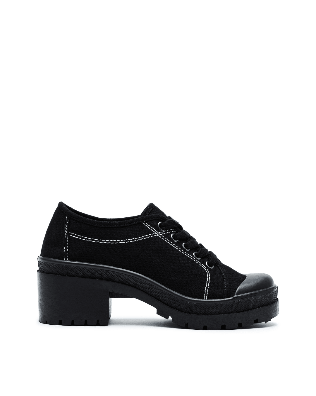 Black lug sole sneaker with white stitching and chunky heel on plain white background