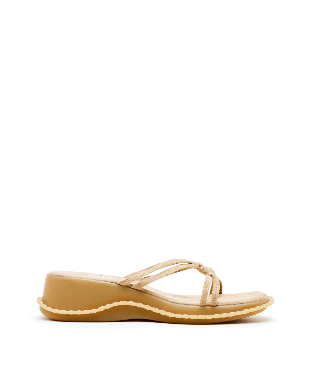 Beige suede wedge sandal with strappy upper and rubber sole on white background