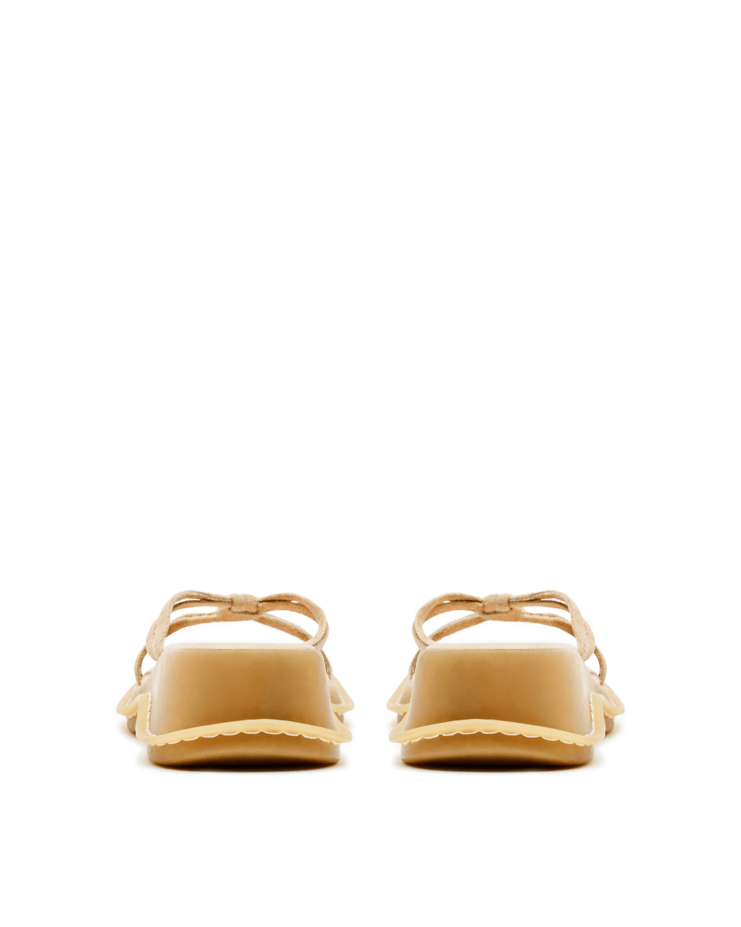 Pair of beige wedge sandals with suede straps, pictured from the back on a white background