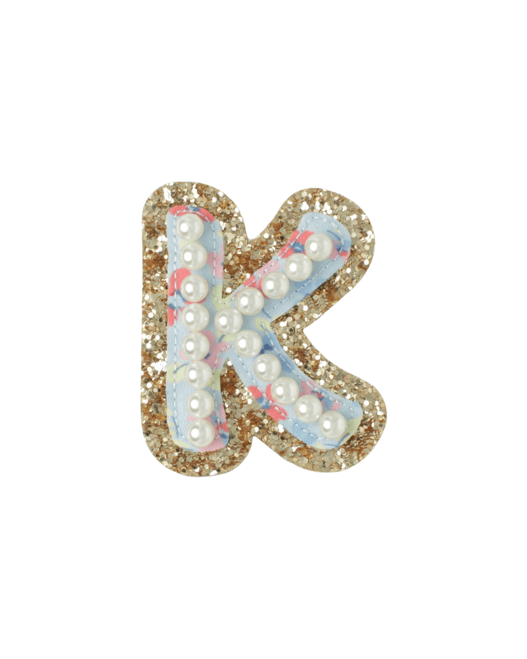 Gold glitter letter K patch with blue floral fabric and pearl accents on white background