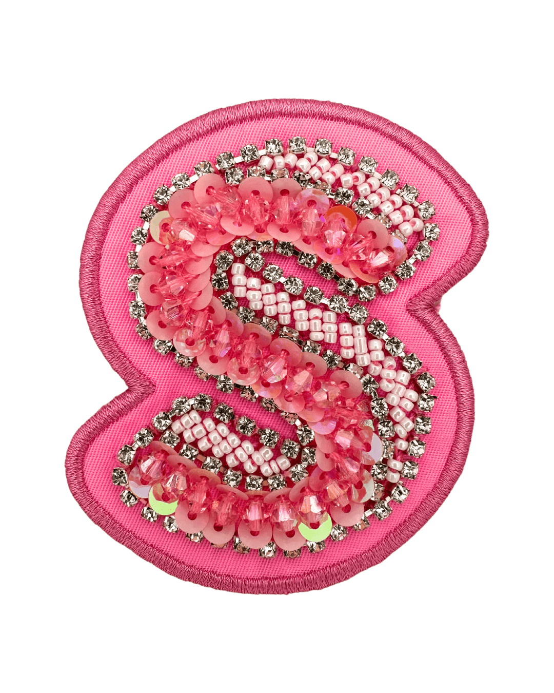 pink letter S patch with sequins, beads, rhinestones, and embroidered border on fabric