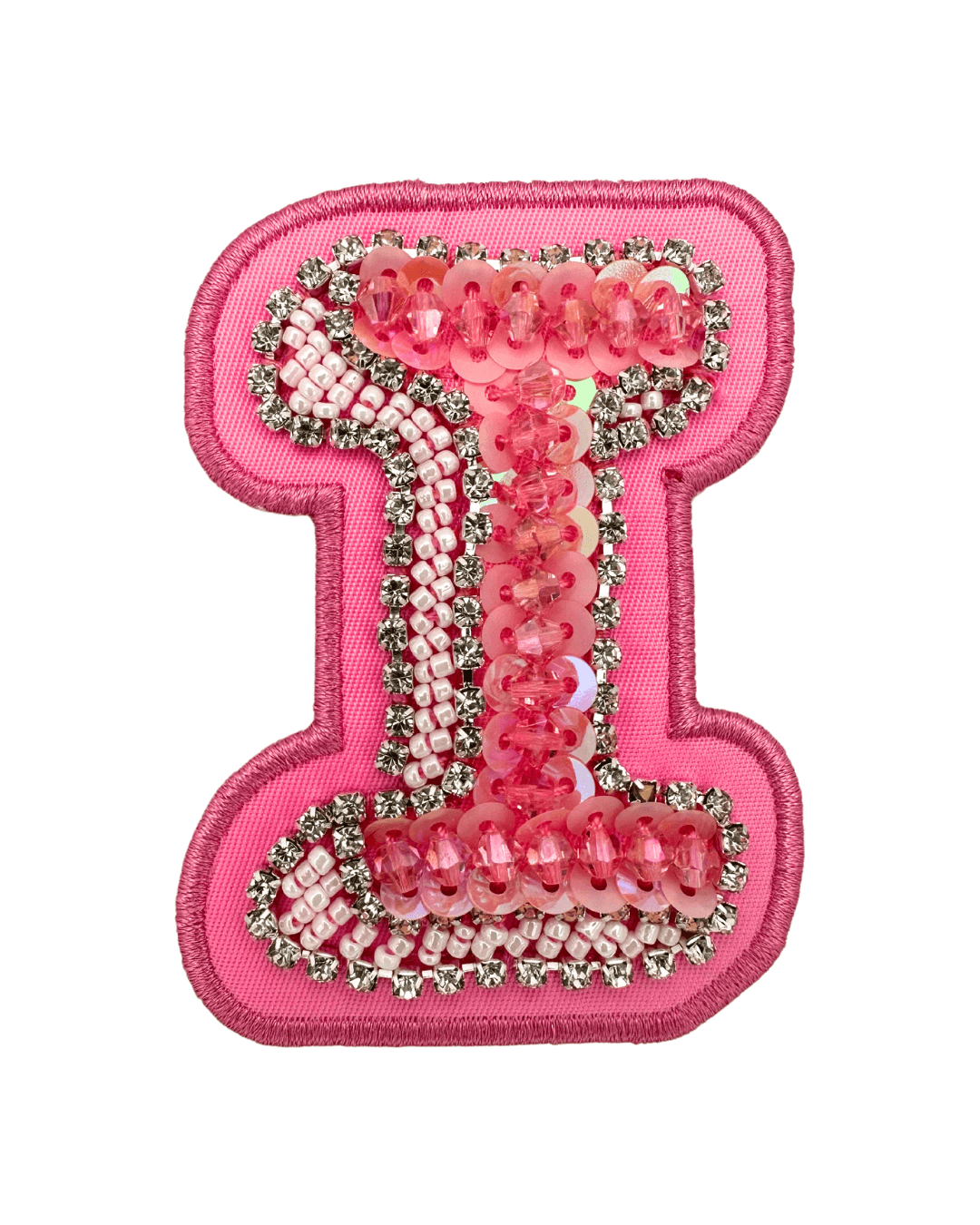 Pink fabric letter patch embellished with sequins, beads, and rhinestones on white background.