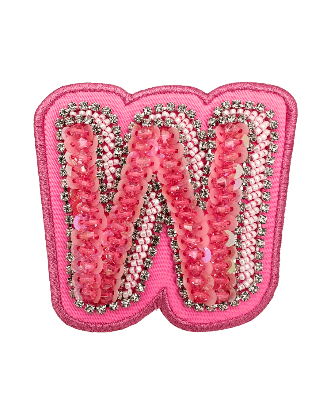 Pink letter patch with sequins, beads, and rhinestone embellishments on fabric