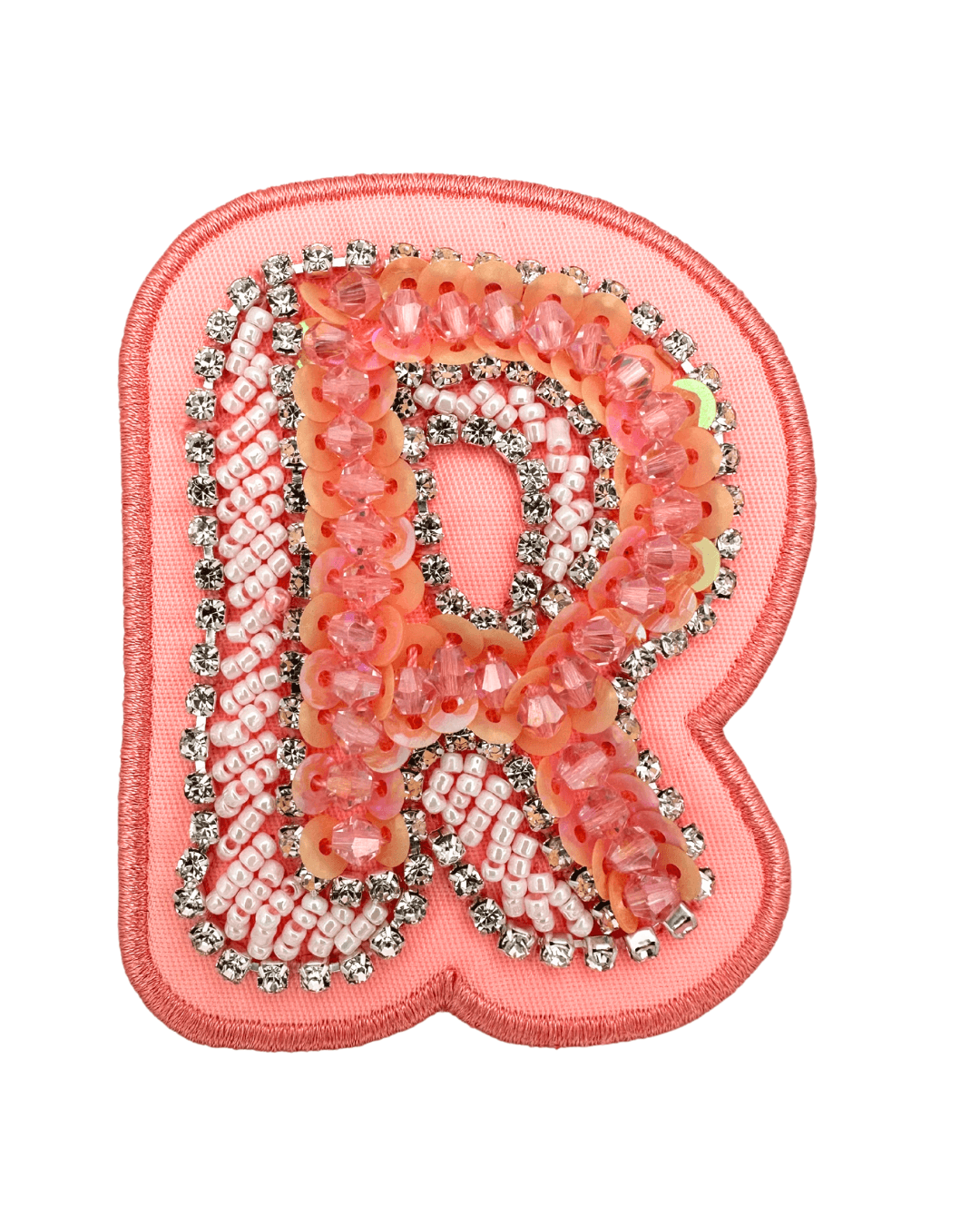 Pink fabric letter patch with sequins, beads, and rhinestone embellishments on white background.