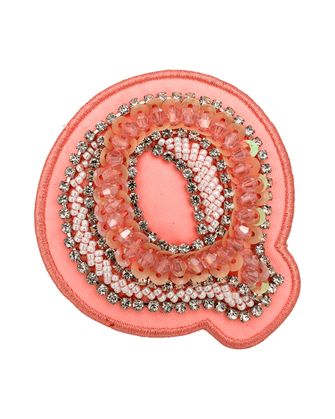 pink embroidered letter patch decorated with beads, sequins, and rhinestones on fabric