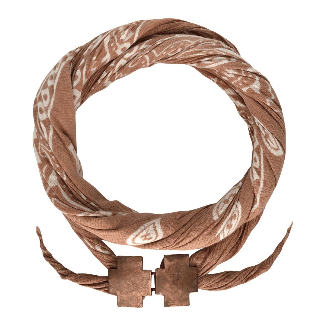 Brown patterned fabric bandana with metal clasp, coiled on a white background