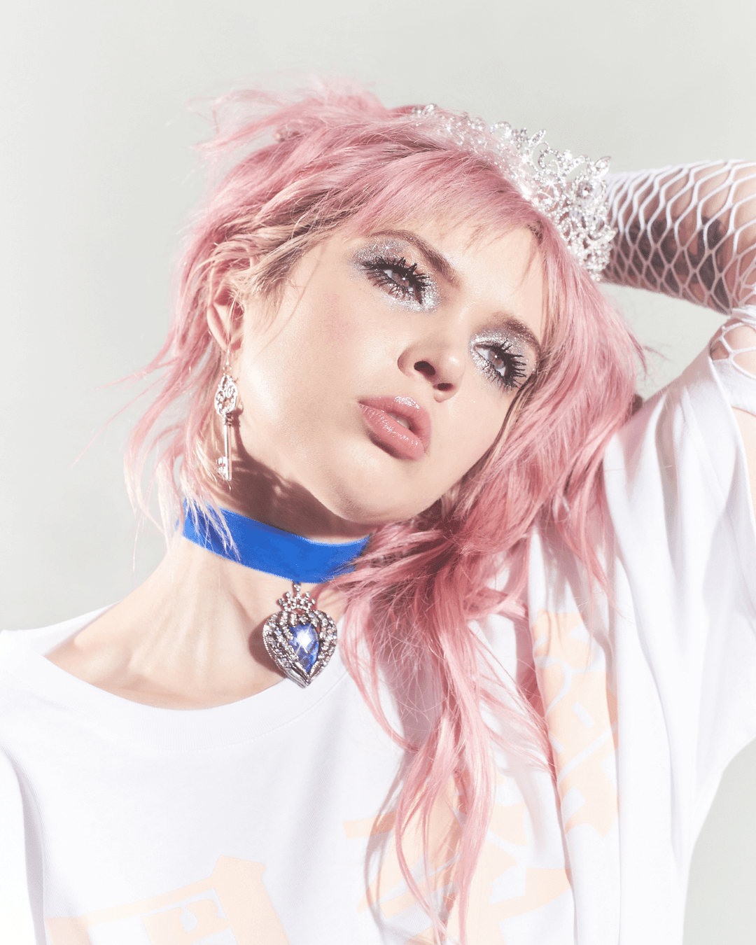 Woman with pink hair wearing a blue velvet choker with a jeweled heart pendant