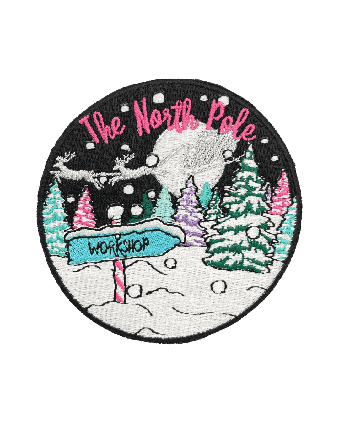 Round embroidered patch with snowy landscape, colorful trees, and a sign reading workshop